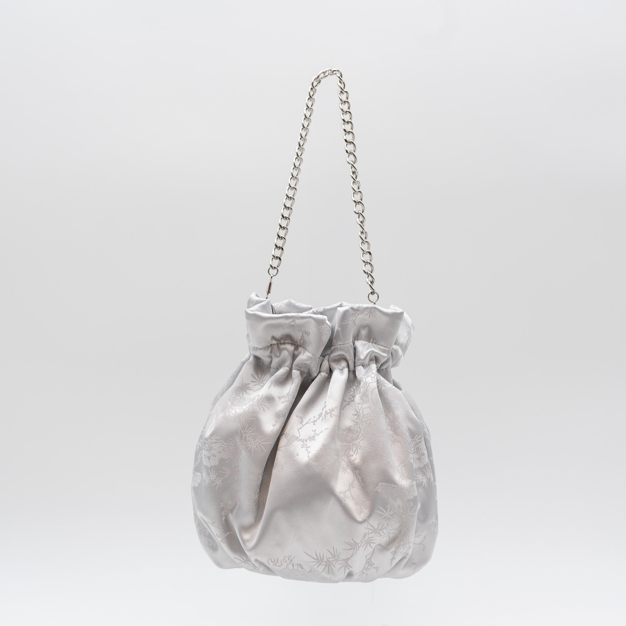 Bolso bombonera de fiesta en raso blanco con bordado floral, cierre fruncido y asa de cadena