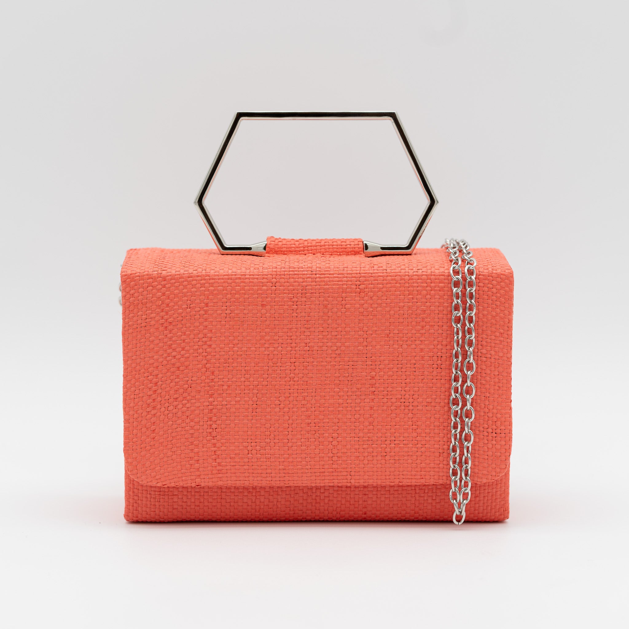 Clutch de fiesta en rafia coral con asa geométrica metálica y cierre magnético, perfecto para bodas y cócteles