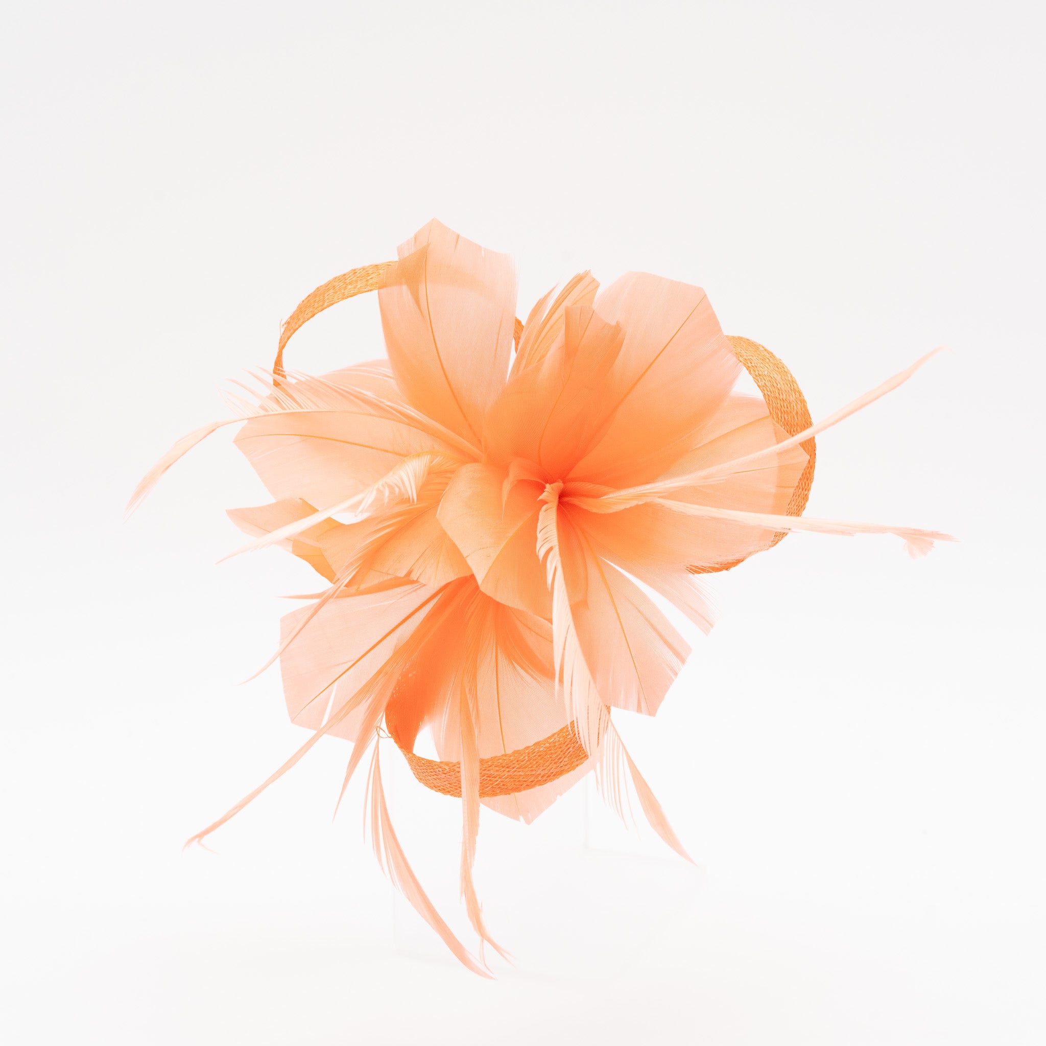 Tocado pequeño coral adornado con plumas elegantes, ideal para eventos especiales